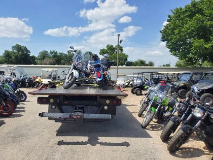 Motorcycles secured on a flatbed at a motorcycle lot