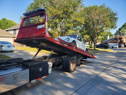 Tow truck with its flatbed tilted for loading