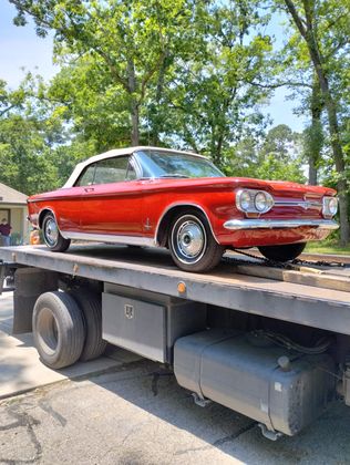 Red classic convertible secured for transport